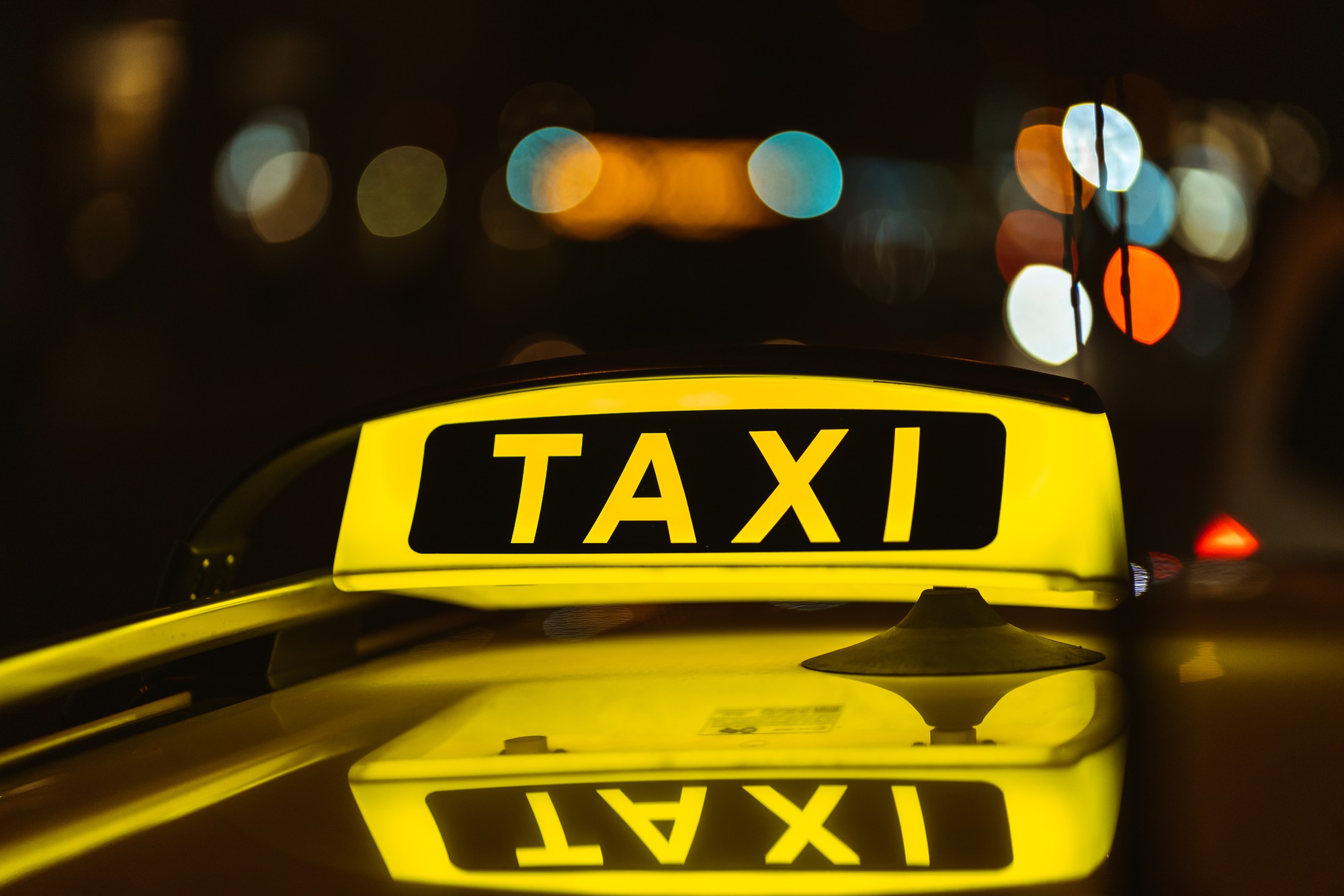 black-yellow-sign-taxi-night-placed-top-car