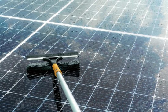 cleaning-solar-panel-with-microfiber-mop-on-wet-roof-solar-panel-orvoltaic-module-maintenance-service-sustainable-resource-solar-power-green-energy-sustainable-development-technology-photo