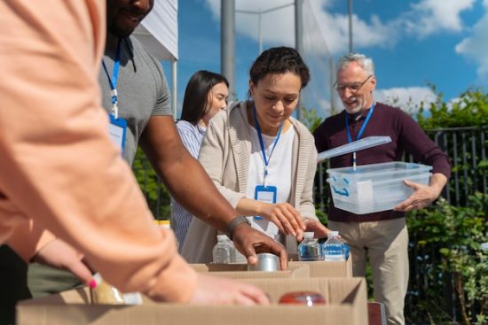 different-people-doing-volunteer-work-with-food_23-2149012166